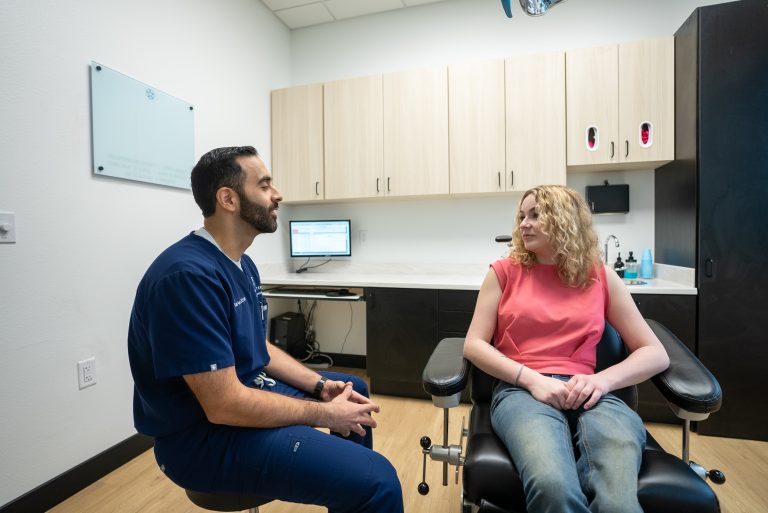 Dr. Anver sits and talks a patient through what to expect before her extraction, the conversation that usually settles most of the nerves people walk in with.