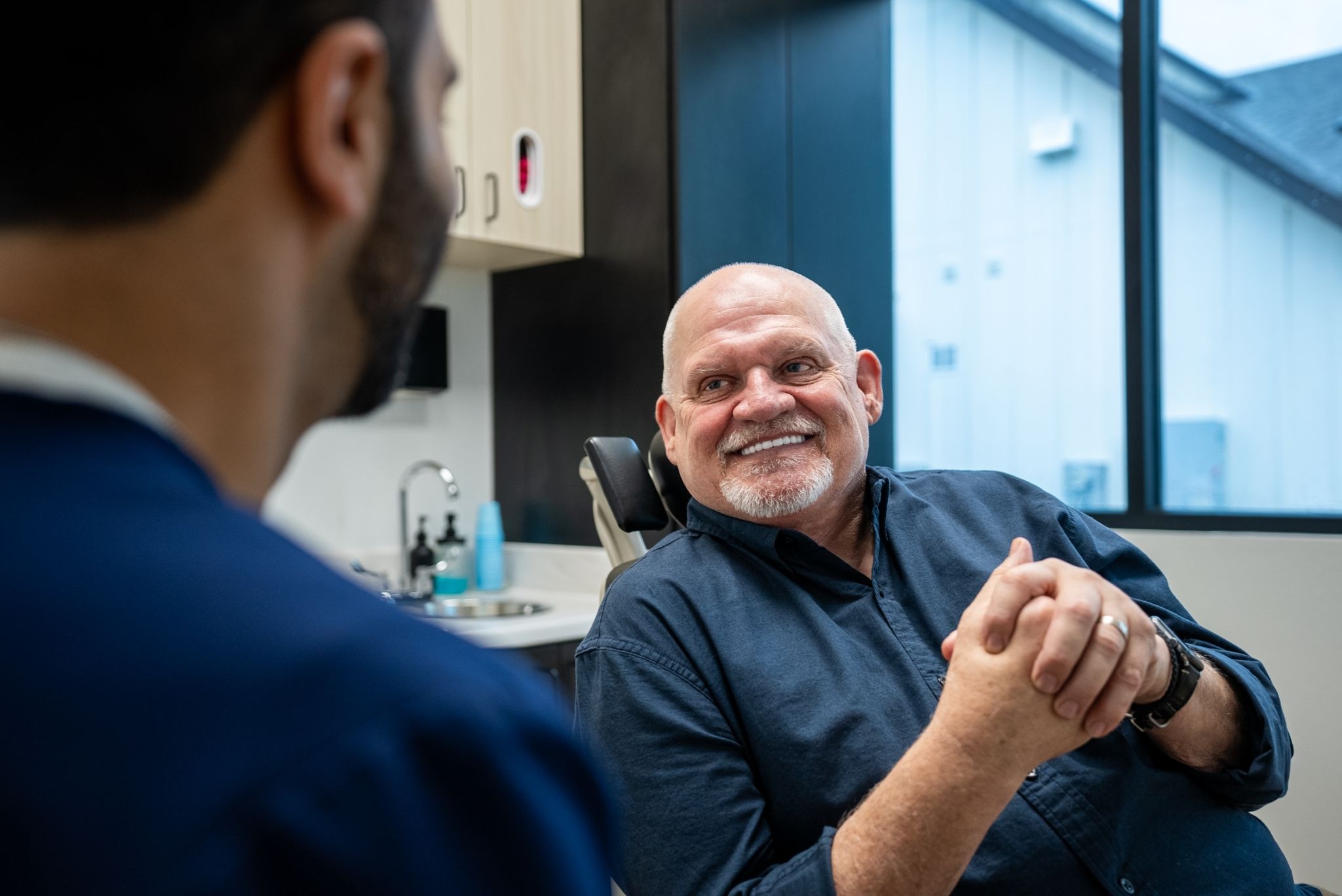 Dr. Tamir Anver shares a smile with his patient after the procedure, the two of them talking through just how easy and painless it turned out to be.