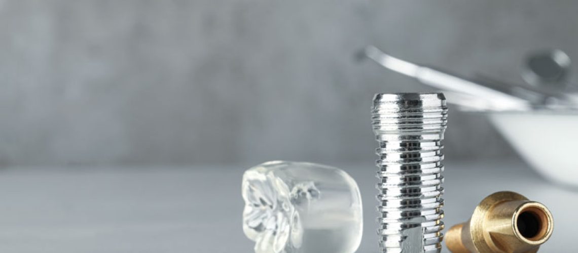 2024-08-Imp1-Parts-of-dental-implant-on-grey-table