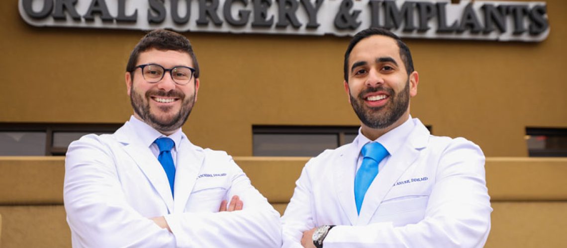 Drs Anver And Vickers Professionally Posing In Front Of The Office, Ready To Talk About The Cost Of Dental Implants