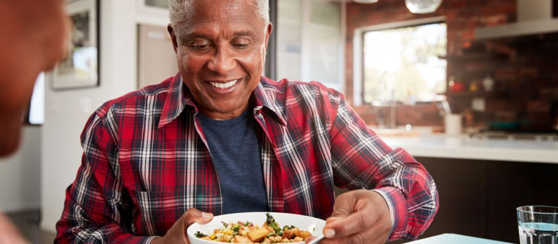 Dental Implant Patient Eating And Smiling