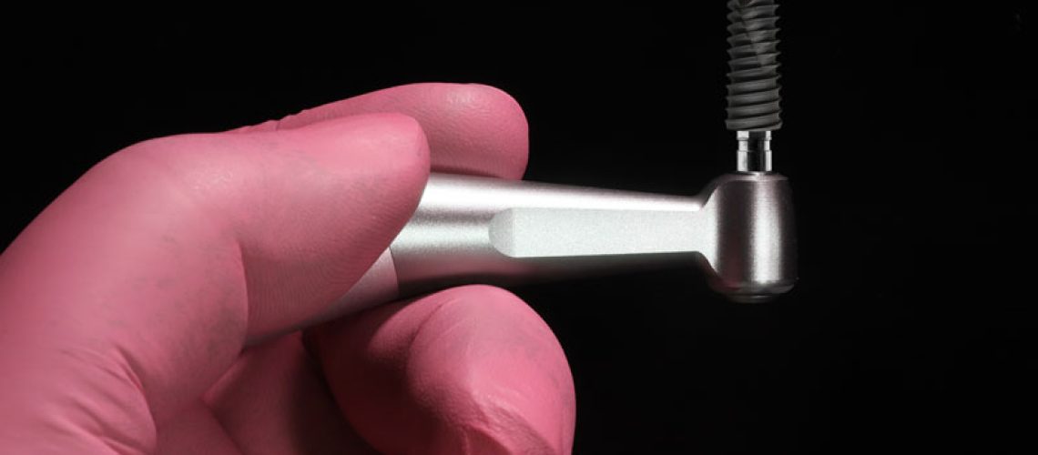 implant-being-held-up